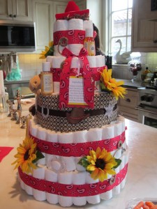 Cowgirl/Western theme diaper cake with sunflowers and hints of red bandanna and brown fabrics!